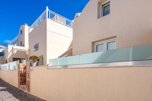 a building with a balcony on the side of it at Reverie Santorini Hotel in Firostefani