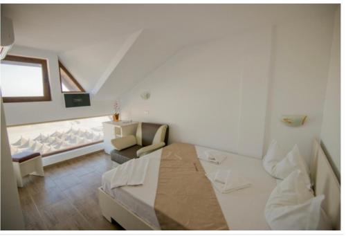 En eller flere senge i et værelse på Complex Turistic Perla Venusului