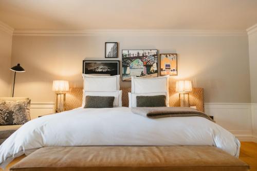 a bedroom with a large white bed with two lamps at Erinvale Estate Hotel & Spa in Somerset West