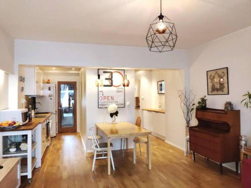 a kitchen and living room with a table and a dining room at Turku Central Nordic Stylish Cozy flat 50m2 in Turku