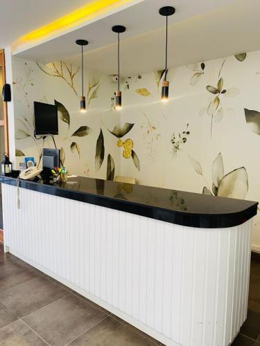 a lobby with a counter with butterflies on the wall at Ranqueles in Villa Carlos Paz