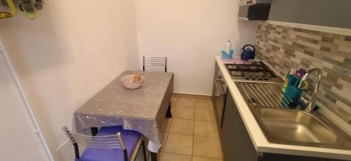a small kitchen with a table and a stove at Super relax - Fiera Milano Rho in Canegrate
