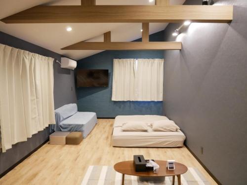 a small room with a bed and a table at HOOD - Vacation STAY 48064v in Amami