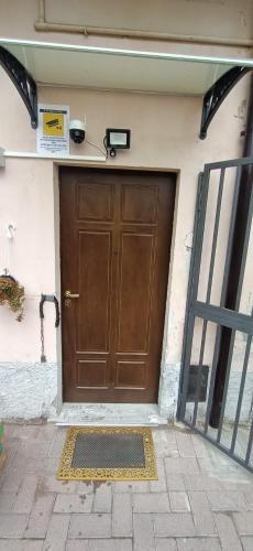 a large brown door with a mat in front of it at Super relax - Fiera Milano Rho in Canegrate