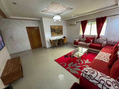 a living room with a red couch and a table at B 2 bedroom apartment in Fez