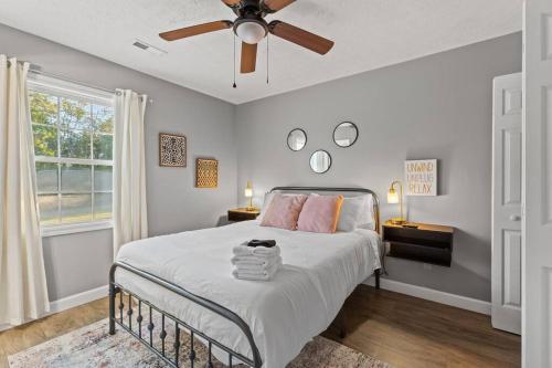 a bedroom with a bed with a ceiling fan at The Luxe/Hot Tub/Putt Putt/10 Miles Shaker Village in Harrodsburg