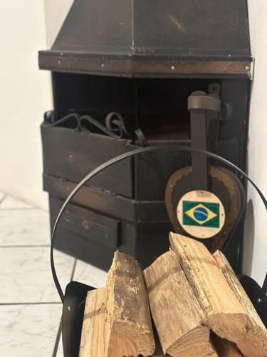 a close up of a stove with some wood at Beira Mar Continental (mágica!) in Florianópolis