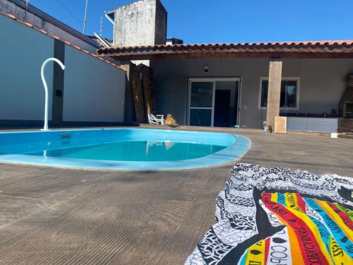 een zwembad in de achtertuin van een huis bij Casa Térrea c/ Piscina - 100mts praia in Caraguatatuba