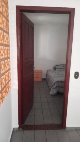 a room with a door leading to a bedroom at Quarto Disponível em Sobrado in Sao Paulo