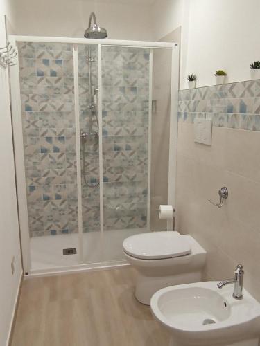 a bathroom with a shower and a toilet and a sink at La Casa di Abe - Cuneo in Cuneo