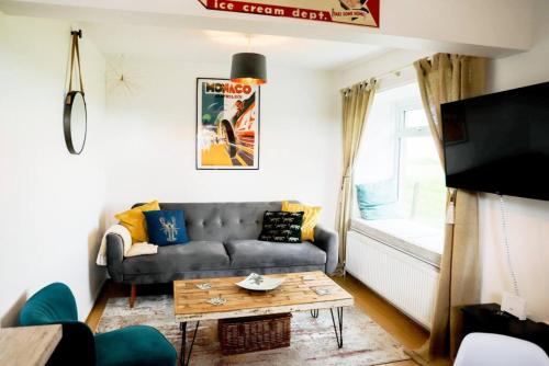 a living room with a couch and a table at Rural retreat near the Sea in East Portlemouth