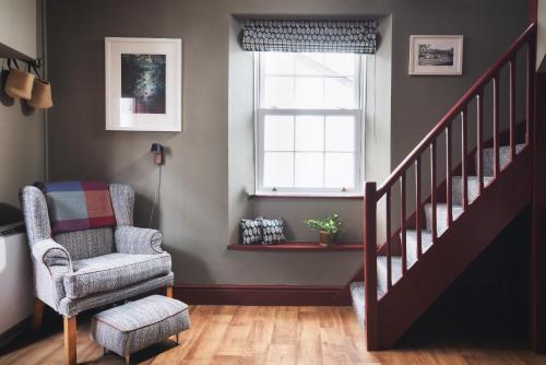 a living room with a chair and a window at Fourteen Providence Place, Calstock, Cornwall, self catering cottage in Calstock