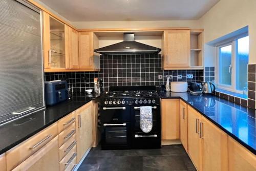 a kitchen with a black stove top oven at Fantastic central home in Dean