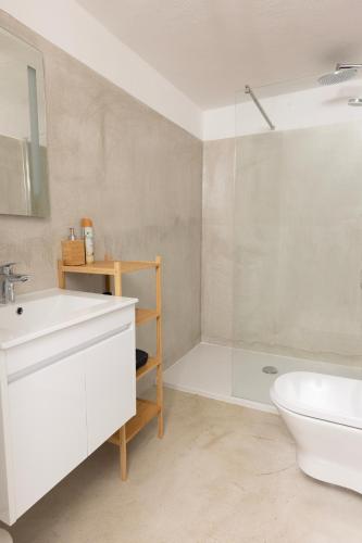 a bathroom with a white sink and a toilet at Villa Floresco in Nerezine