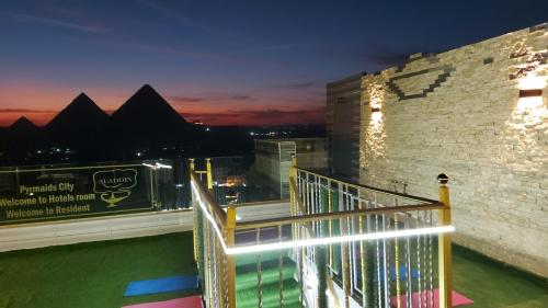 a view of the pyramids from a balcony at night at ALADDIN PYRAMIDS CITY in Cairo