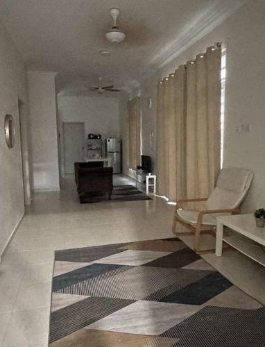 a living room with a chair and a piano at Homestay Taman Tiara Paka Full AC Free Wi-fi & COWAY in Paka