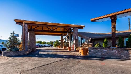 a gas station with awning in a parking lot at Best Western Outlaw Inn in Rock Springs