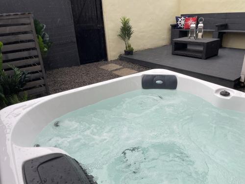 a jacuzzi tub in a yard with at Château by the Sea - Hotel style 3 bed optional hot tub in Newbiggin-by-the-Sea