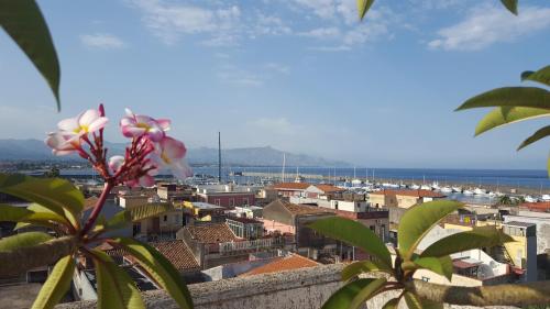 a view of a city with a pink flower at Casa delle Pomelie - Taormina & Etna Panoramic Views in Riposto