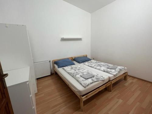 a small bedroom with a bed in a room at Fantomas Apartments*** TH 32.1 - 3 Bedroom+Living room Apartments in Szombathely