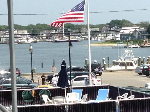 an american flag flying over a parking lot with a marina at Ocean Street Inn in Hyannis