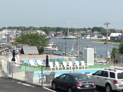 two cars parked in front of a marina with chairs at Ocean Street Inn in Hyannis