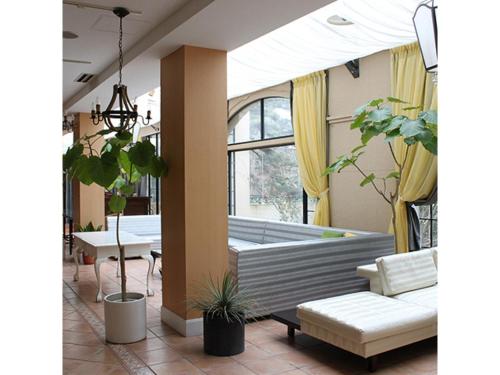 une véranda avec un canapé et des chaises dans l'établissement Hotel Crystal Palace - Vacation STAY 61208v, à Hitachinaka
