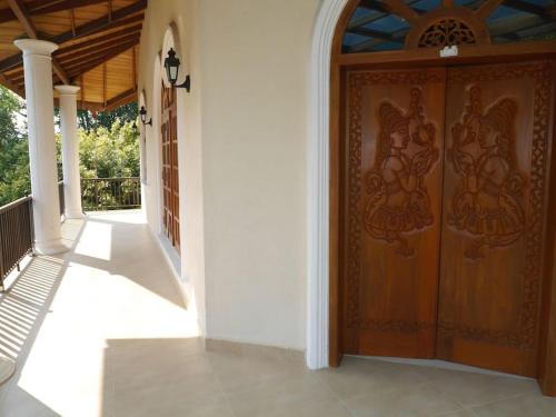 an entrance to a house with a wooden door at Caro Villa in Induruwa