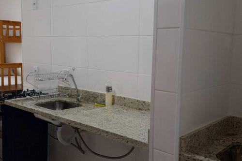 a kitchen with a sink and a counter top at Apartamento em Cachoeira Pta in Cachoeira Paulista