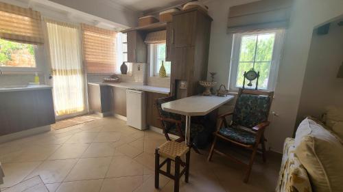 a kitchen with a table and chairs and windows at House near Marina, Yachts, Boats. 4,5 BR in Torba