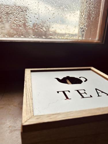 a sign in a wooden box in front of a window at Casa di Mare in Montalto di Castro