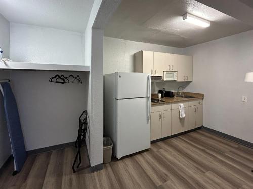 a kitchen with a white refrigerator in a room at Studio 6 Lubbock, TX in Lubbock