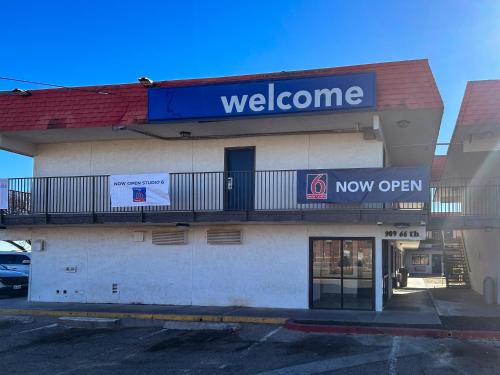 a welcome sign on the side of a building at Studio 6 Lubbock, TX in Lubbock