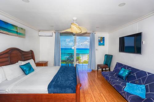 a bedroom with a bed and a couch at Montego Bay Club Apartments in Montego Bay