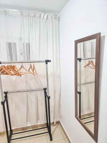 a mirror and a rack with shoes in a room at Le Superbe - Sidi Bou Saïd in Dar Mimoun Bey