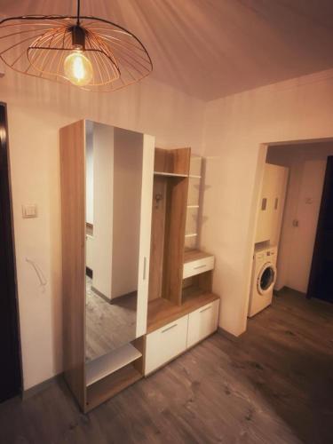 a room with a large cabinet and a washing machine at RR Residence in Craiova