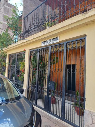 a building with a gate on the side of it at Posada de Mama in Cusco
