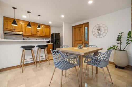 a kitchen with a wooden table and chairs at Alcazar de Oviedo by EE Hoteles in Medellín
