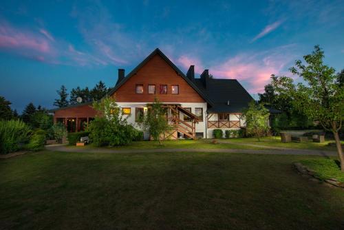 a large house with a large yard in front of it at Villa Bezycer in Gowidlino