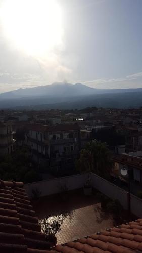 a view of a city from the roof of a building at Casa delle Pomelie - Taormina & Etna Panoramic Views in Riposto