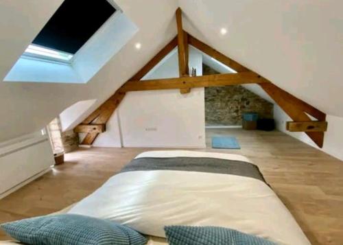 a bedroom with a bed in a attic at Maison de ville in Bouguenais
