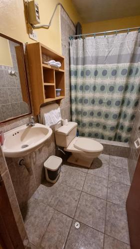 a bathroom with a sink and a toilet and a shower at Lili´s House in Huaraz