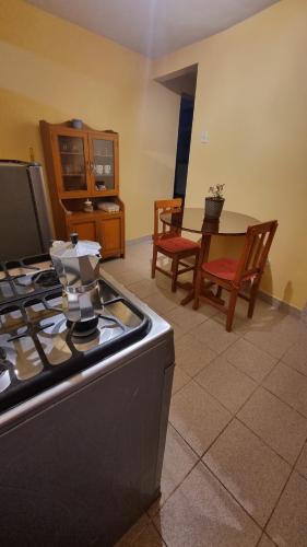 a kitchen with a stove and a dining room at Lili´s House in Huaraz
