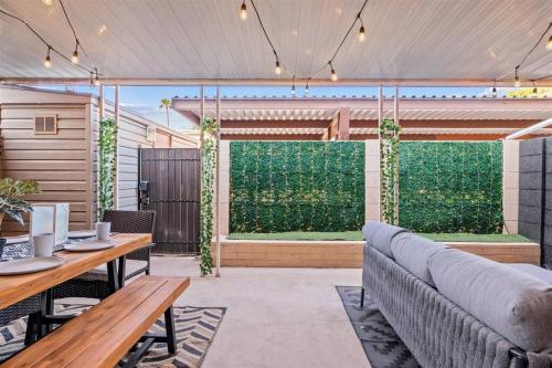 an outdoor patio with a couch and a fence at The Scott Pad - Remodeled space, large pool, centrally located in the heart of Scottsdale! in Scottsdale