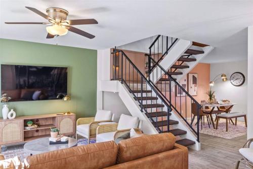 a living room with a couch and a staircase at The Scott Pad - Remodeled space, large pool, centrally located in the heart of Scottsdale! in Scottsdale