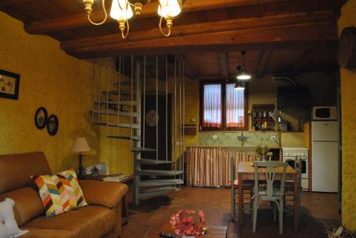 a living room with a couch and a table at Masia El Riscle - Moli Del Pont in Cornudella