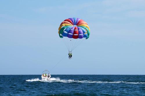 a person in the water with a parachute at Paradise Duplex A in Gulf Shores