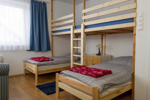 two bunk beds with red pillows on them in a room at Samostatný dom s bazénom v Rajeckej doline 