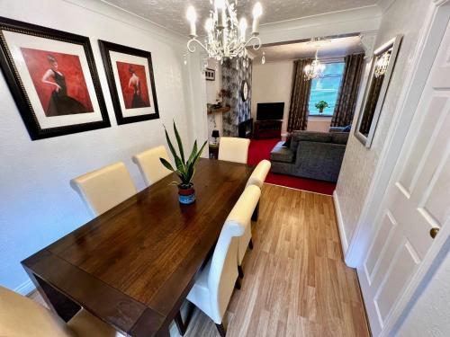 a dining room with a table and a living room at 50 Etherley Lane in Bishop Auckland