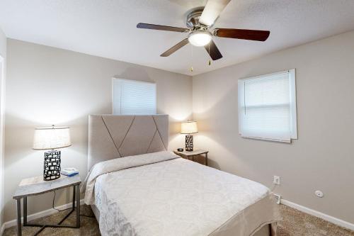a bedroom with a bed and a ceiling fan at Garden Cottage in Rapid City